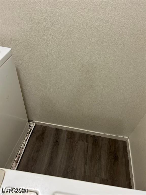 laundry view of wood finished floors and baseboards