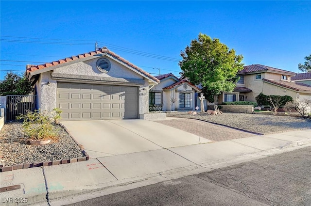 6771 Shelter Ln, Las Vegas, NV 89103 - view of front of property with an attached garage, concrete driveway, stucco siding, and a tiled roof