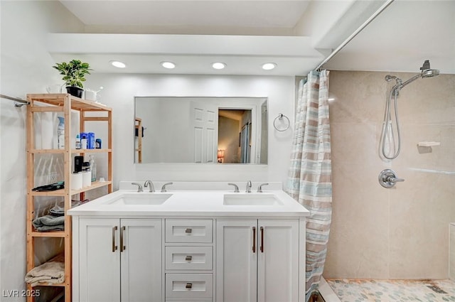 6771 Shelter Ln, Las Vegas, NV 89103 - bathroom featuring a tile shower, double vanity, and recessed lighting