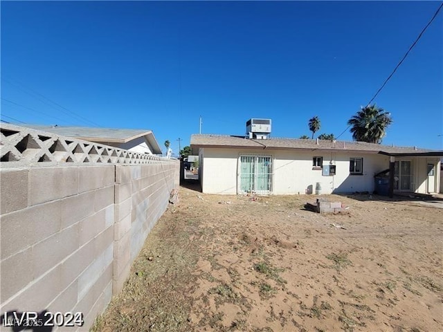 back of house featuring fence