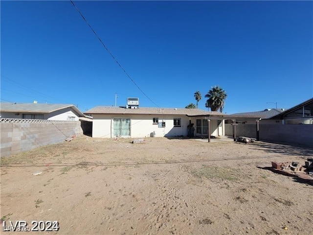 rear view of property with a fenced backyard