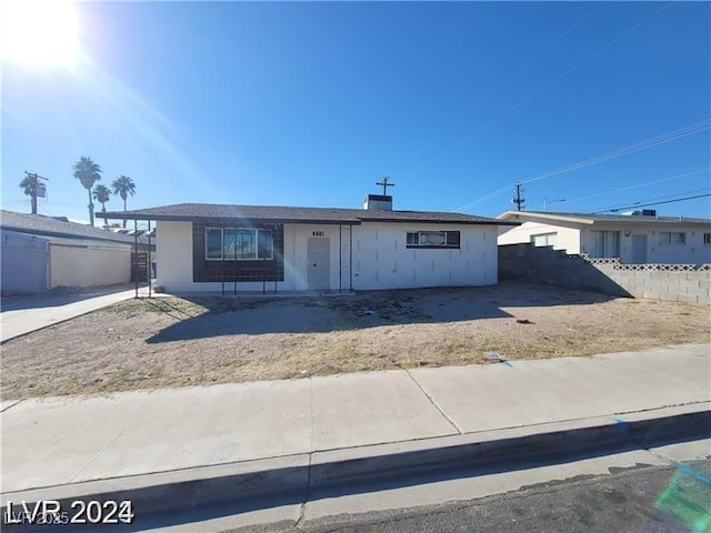 single story home featuring fence