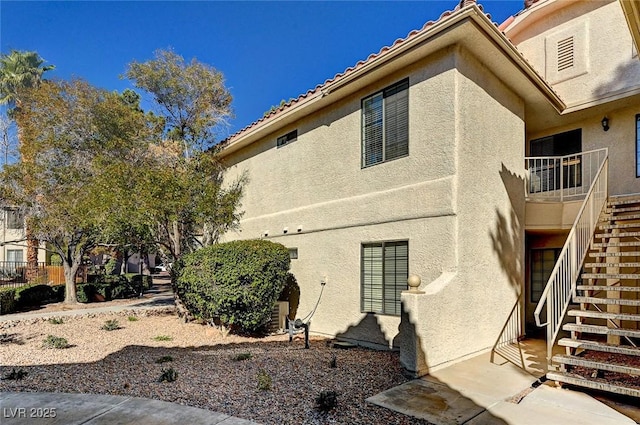 2633 S Durango Dr Unit 201, Las Vegas, NV 89117 - rear view of house with stairs and stucco siding