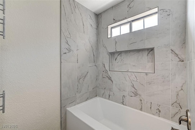 2633 S Durango Dr Unit 201, Las Vegas, NV 89117 - full bathroom with washtub / shower combination and a textured wall