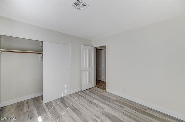 2633 S Durango Dr Unit 201, Las Vegas, NV 89117 - unfurnished bedroom featuring light wood-style flooring, a closet, and baseboards