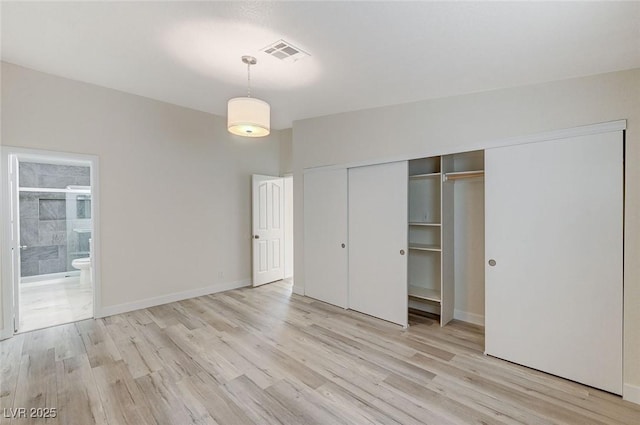 2633 S Durango Dr Unit 201, Las Vegas, NV 89117 - unfurnished bedroom with light wood-style flooring, a closet, ensuite bath, and baseboards