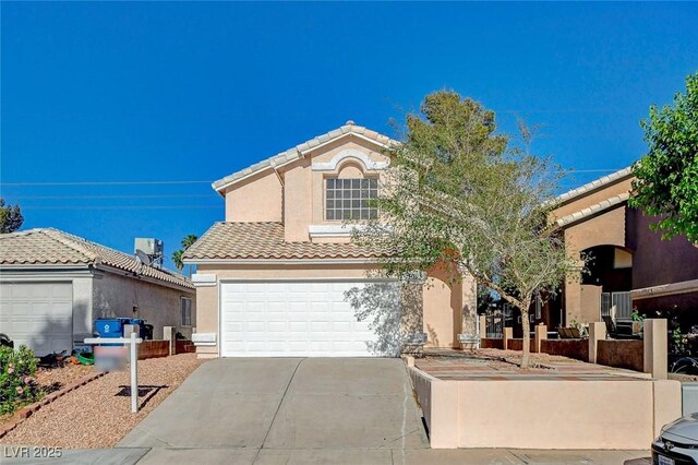 mediterranean / spanish-style home with driveway, stucco siding, a garage, and a tile roof