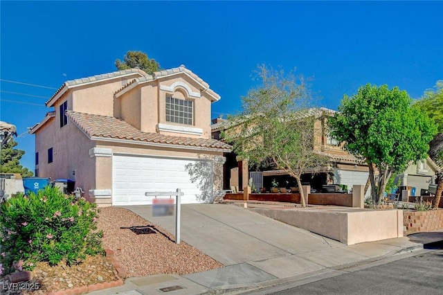 view of front of home with a garage, concrete driveway, stucco siding, and a tiled roof