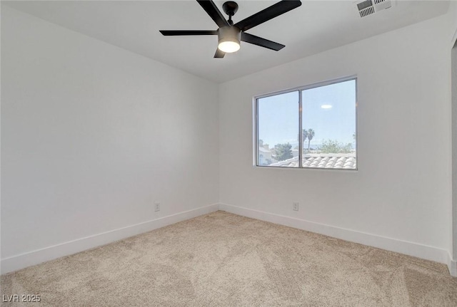 carpeted spare room with baseboards and ceiling fan