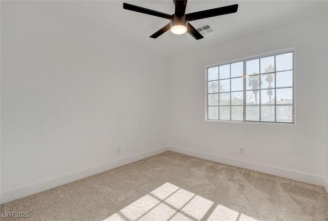 spare room featuring carpet flooring, baseboards, and ceiling fan