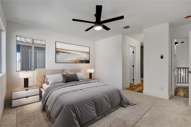 carpeted bedroom with baseboards and a ceiling fan