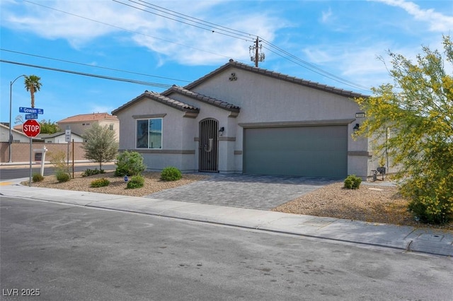 3556 Valley Lily St, North Las Vegas, NV 89032 - mediterranean / spanish-style house featuring stucco siding, an attached garage, driveway, and a tile roof