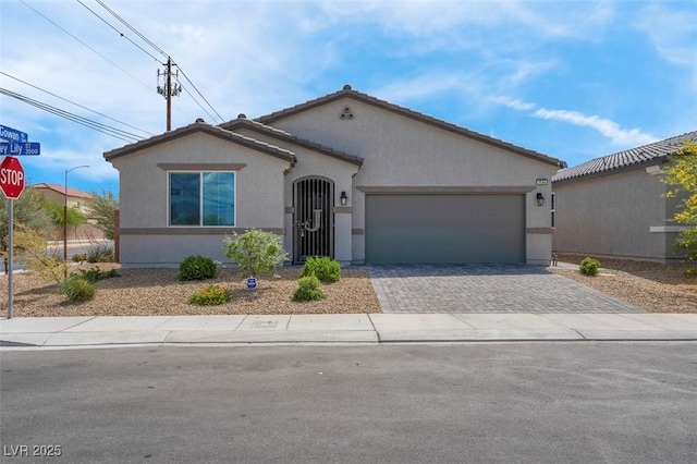 3556 Valley Lily St, North Las Vegas, NV 89032 - mediterranean / spanish-style house featuring driveway, stucco siding, and an attached garage