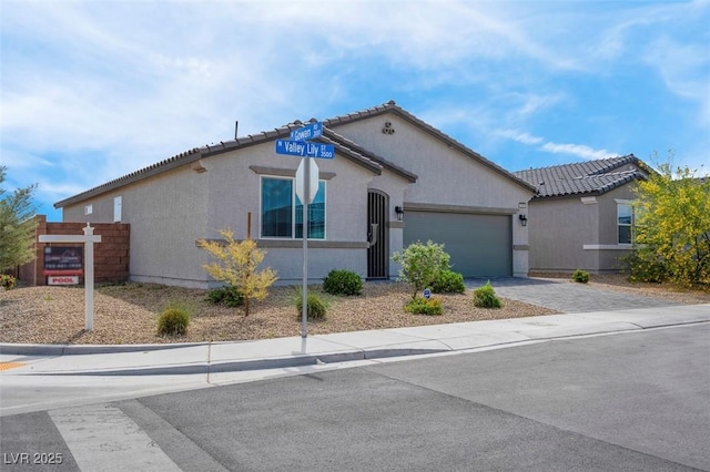 3556 Valley Lily St, North Las Vegas, NV 89032 - view of front of property featuring driveway, an attached garage, stucco siding, and a tile roof
