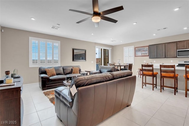 3556 Valley Lily St, North Las Vegas, NV 89032 - living area with ceiling fan, plenty of natural light, light tile patterned floors, recessed lighting, and baseboards