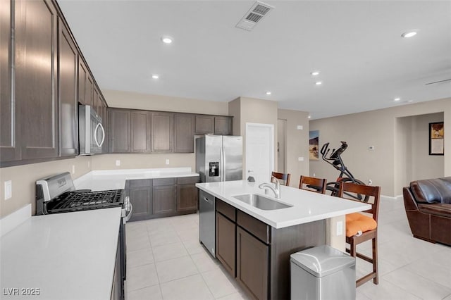 3556 Valley Lily St, North Las Vegas, NV 89032 - kitchen with a sink, appliances with stainless steel finishes, open floor plan, light tile patterned flooring, and a center island with sink