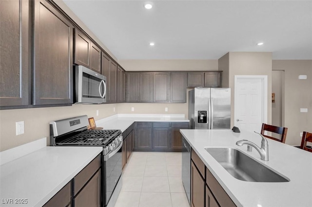 3556 Valley Lily St, North Las Vegas, NV 89032 - kitchen with stainless steel appliances, a sink, dark brown cabinets, light countertops, and recessed lighting