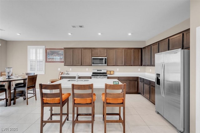 3556 Valley Lily St, North Las Vegas, NV 89032 - kitchen featuring stainless steel appliances, light tile patterned flooring, a kitchen island with sink, light countertops, and recessed lighting