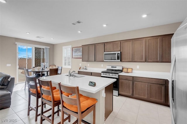 3556 Valley Lily St, North Las Vegas, NV 89032 - kitchen with stainless steel appliances, a sink, light tile patterned flooring, light countertops, and recessed lighting