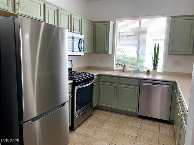 9236 Canalino Dr, Las Vegas, NV 89134 - kitchen with stainless steel appliances, a sink, green cabinets, and light countertops