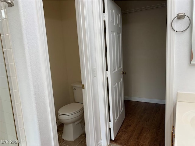 9236 Canalino Dr, Las Vegas, NV 89134 - bathroom with toilet, wood finished floors, and baseboards