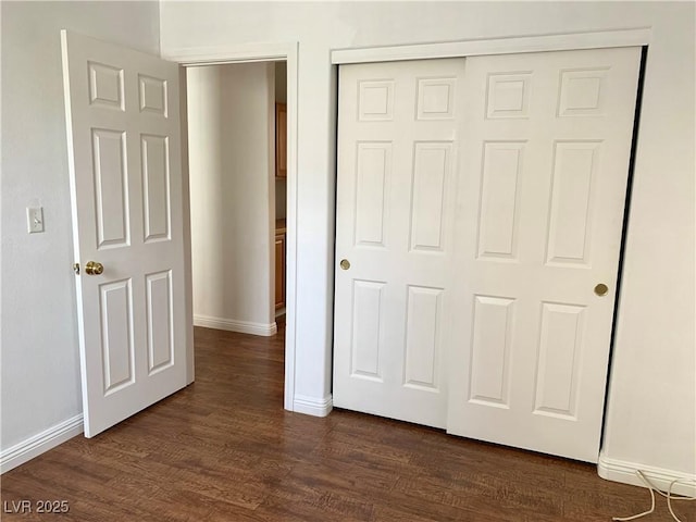9236 Canalino Dr, Las Vegas, NV 89134 - unfurnished bedroom featuring dark wood-style floors, baseboards, and a closet