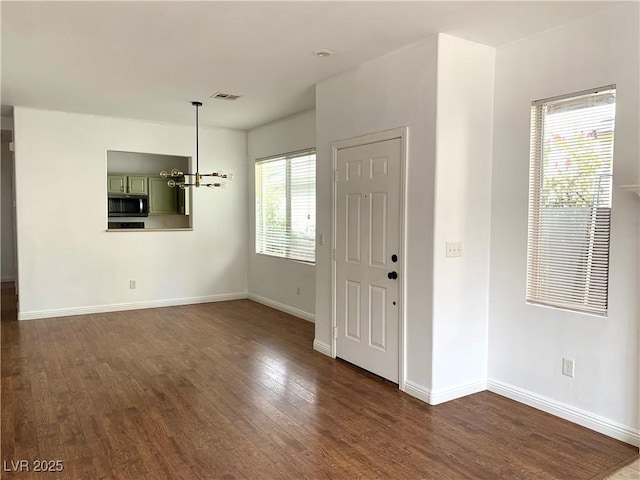 9236 Canalino Dr, Las Vegas, NV 89134 - entryway featuring a chandelier, dark wood-style floors, and baseboards