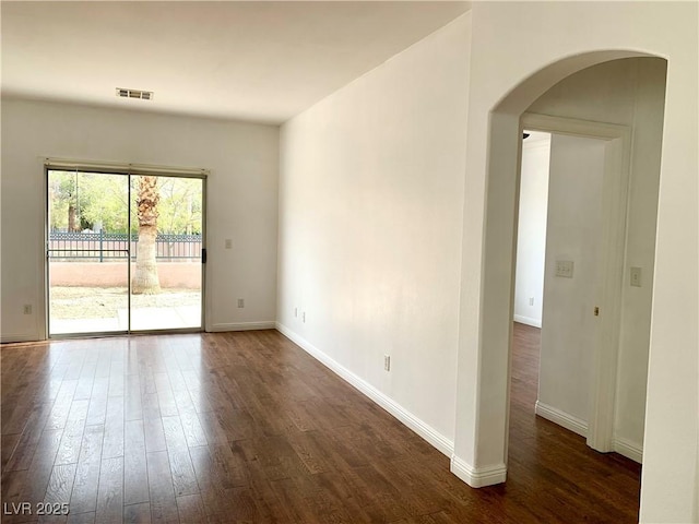 9236 Canalino Dr, Las Vegas, NV 89134 - unfurnished room featuring dark wood finished floors, arched walkways, and baseboards