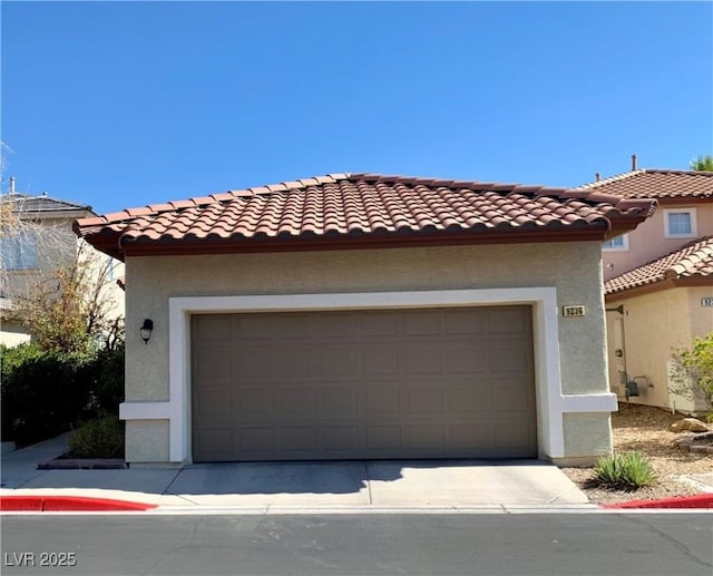 9236 Canalino Dr, Las Vegas, NV 89134 - mediterranean / spanish-style house featuring stucco siding, a tiled roof, concrete driveway, and a garage