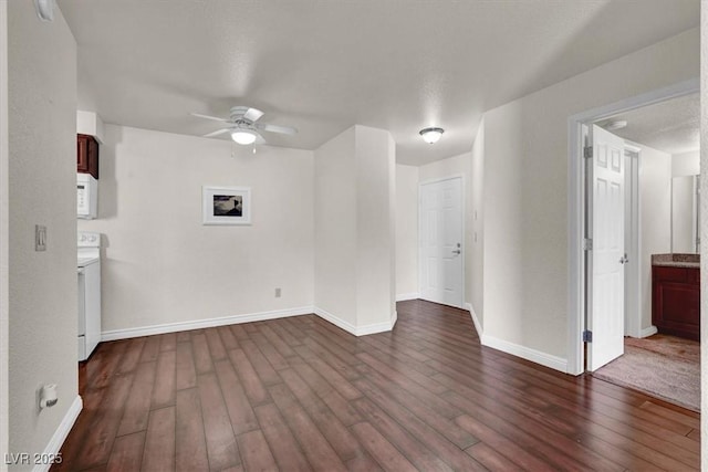 unfurnished room featuring ceiling fan, dark wood-type flooring, and baseboards