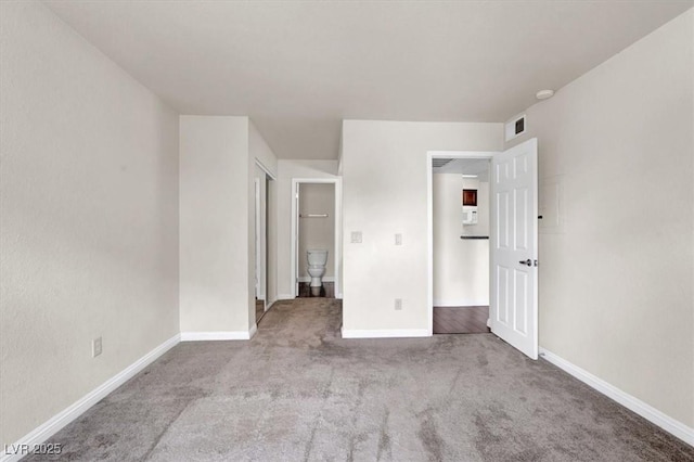 unfurnished bedroom with carpet floors and baseboards