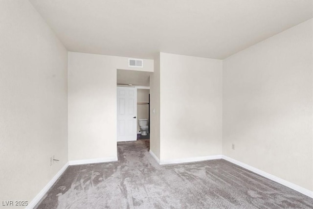 carpeted spare room with baseboards