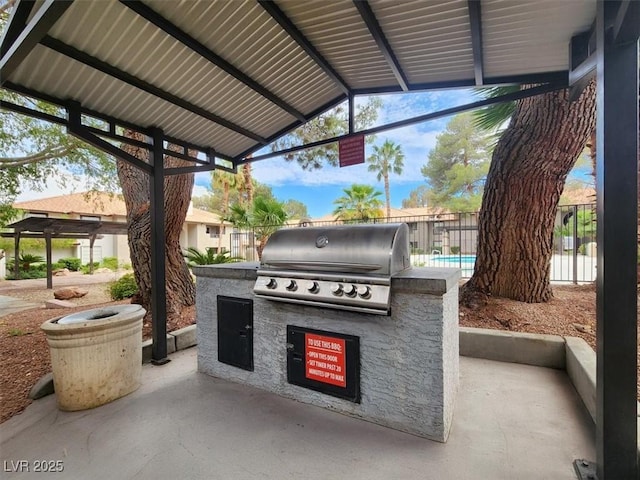 view of patio / terrace with area for grilling, exterior kitchen, and fence