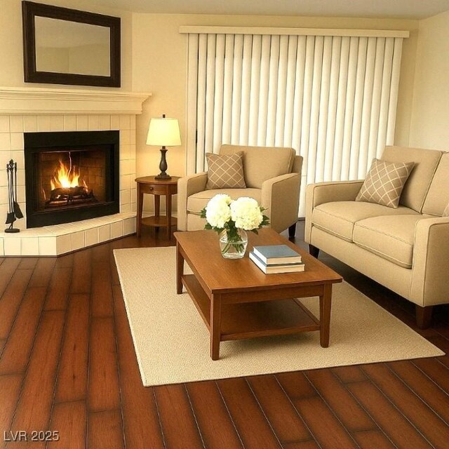 living room featuring hardwood / wood-style floors and a tiled fireplace