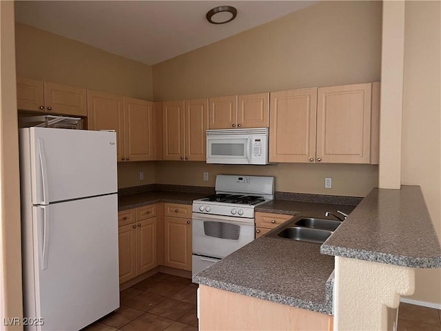 8688 Tomnitz Ave Unit 101, Las Vegas, NV 89178 - kitchen featuring white appliances, a peninsula, dark countertops, dark tile patterned flooring, and light brown cabinets