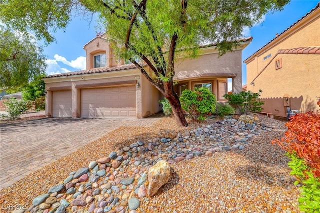 1033 Logan Patrick Dr, Henderson, NV 89052 - mediterranean / spanish house with stucco siding, driveway, a tile roof, and an attached garage