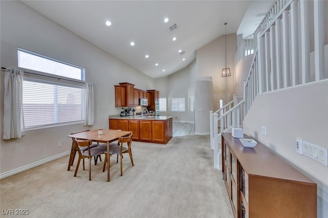 1033 Logan Patrick Dr, Henderson, NV 89052 - dining area with high vaulted ceiling, stairs, light colored carpet, recessed lighting, and baseboards