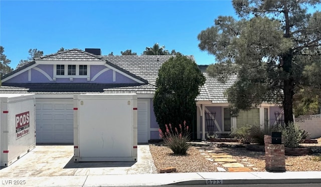 view of front facade featuring concrete driveway and stucco siding