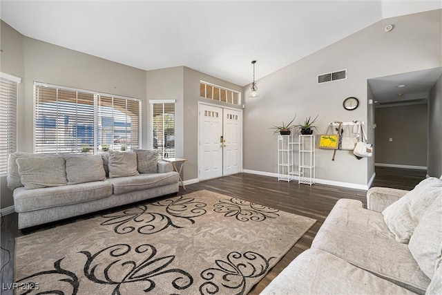 5912 Hollowridge Rd, North Las Vegas, NV 89031 - living room featuring baseboards, dark wood-style floors, and high vaulted ceiling