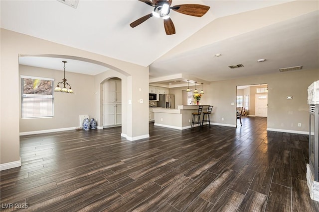 5912 Hollowridge Rd, North Las Vegas, NV 89031 - unfurnished living room featuring ceiling fan, dark wood-style flooring, arched walkways, baseboards, and lofted ceiling
