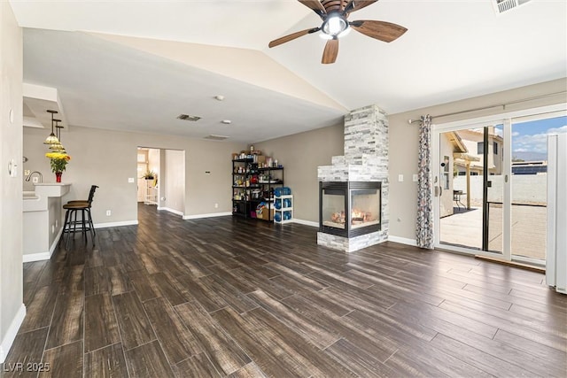 5912 Hollowridge Rd, North Las Vegas, NV 89031 - unfurnished living room with a ceiling fan, wood finished floors, a fireplace, lofted ceiling, and baseboards