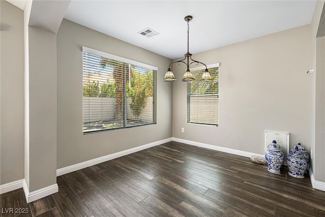 5912 Hollowridge Rd, North Las Vegas, NV 89031 - unfurnished dining area with wood finished floors, baseboards, and a chandelier