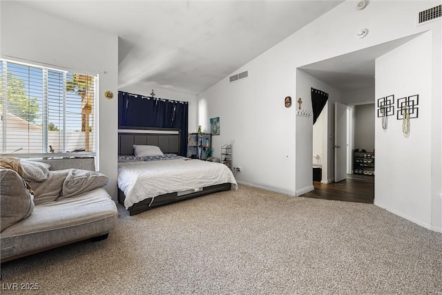 5912 Hollowridge Rd, North Las Vegas, NV 89031 - carpeted bedroom featuring vaulted ceiling and baseboards