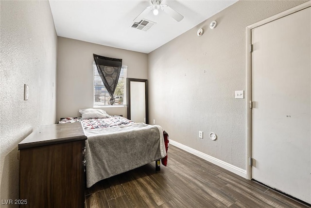 5912 Hollowridge Rd, North Las Vegas, NV 89031 - bedroom with dark wood finished floors, baseboards, a textured wall, and a ceiling fan