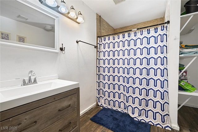 5912 Hollowridge Rd, North Las Vegas, NV 89031 - full bath with curtained shower, wood finished floors, vanity, and baseboards