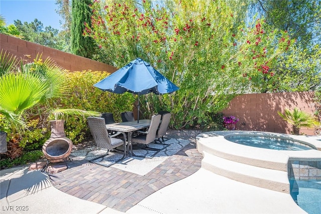 11112 Pine Greens Ct, Las Vegas, NV 89144 - view of patio / terrace featuring a fenced backyard, an in-ground hot tub, outdoor dining space, and a fire pit