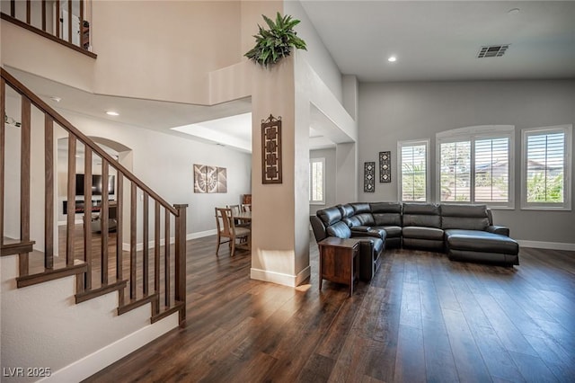 11112 Pine Greens Ct, Las Vegas, NV 89144 - living area with dark wood finished floors, stairs, baseboards, recessed lighting, and a high ceiling