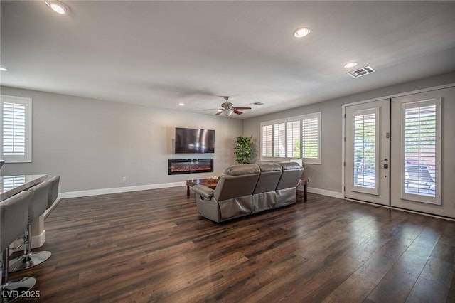 11112 Pine Greens Ct, Las Vegas, NV 89144 - living area with dark wood-style floors, a ceiling fan, a glass covered fireplace, baseboards, and recessed lighting