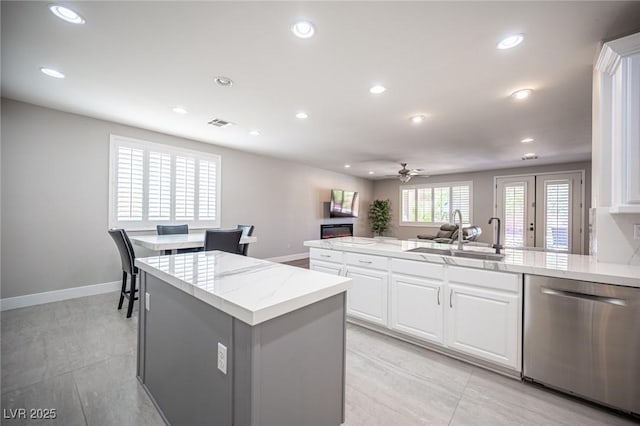 11112 Pine Greens Ct, Las Vegas, NV 89144 - kitchen featuring dishwasher, a sink, a ceiling fan, recessed lighting, and white cabinetry
