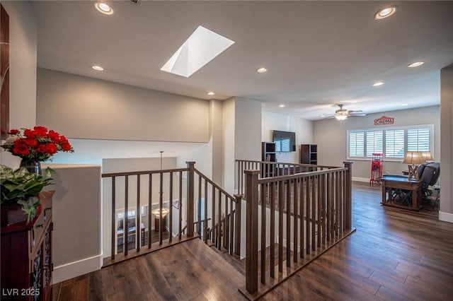 11112 Pine Greens Ct, Las Vegas, NV 89144 - hallway featuring an upstairs landing, wood finished floors, recessed lighting, baseboards, and a skylight